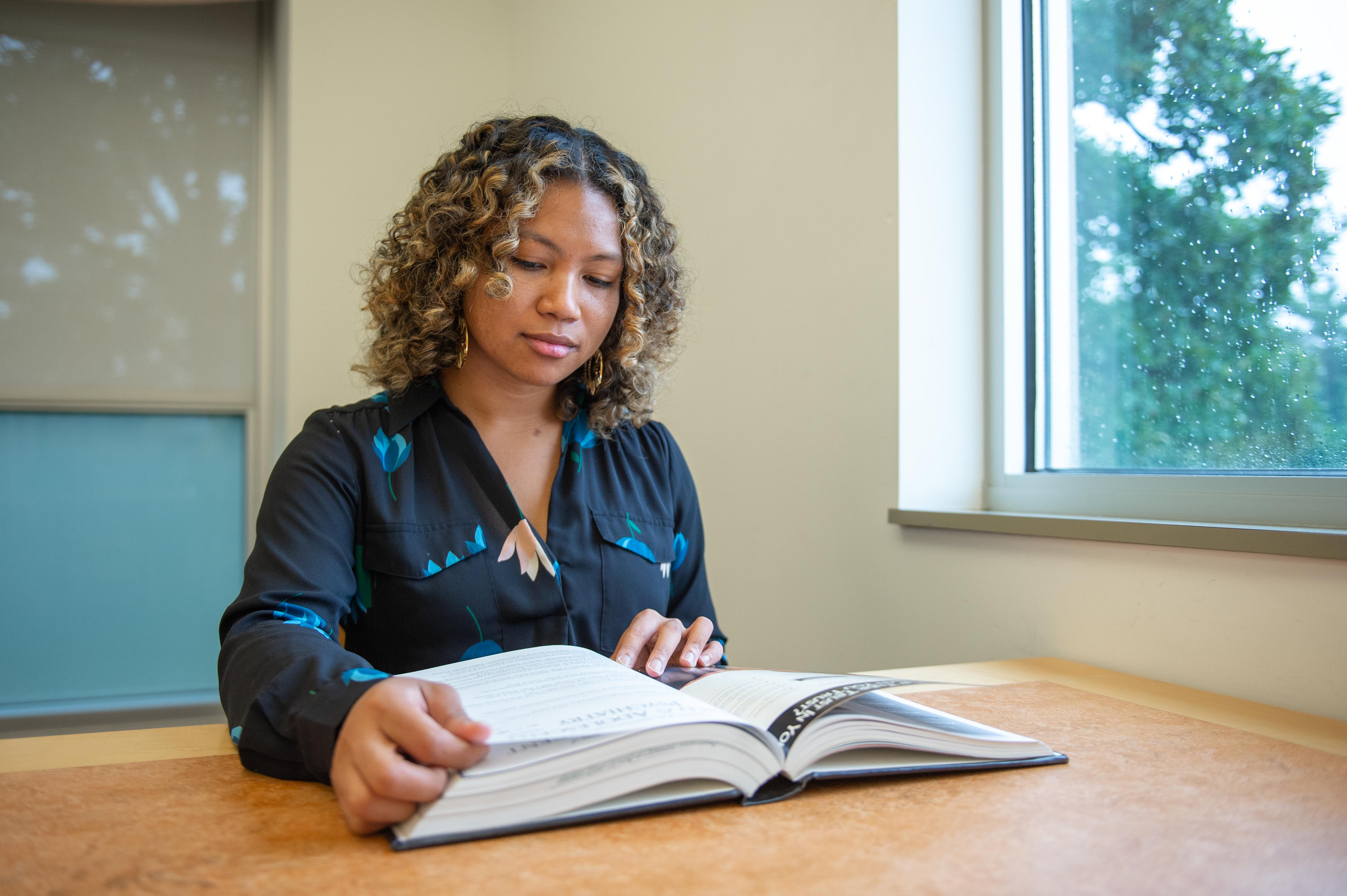 Woman reading a textbook.